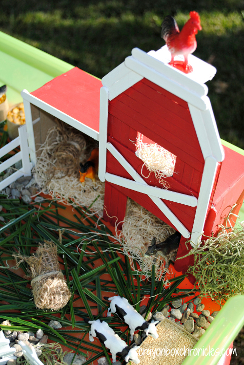 Red barn made of popsicle sticks.