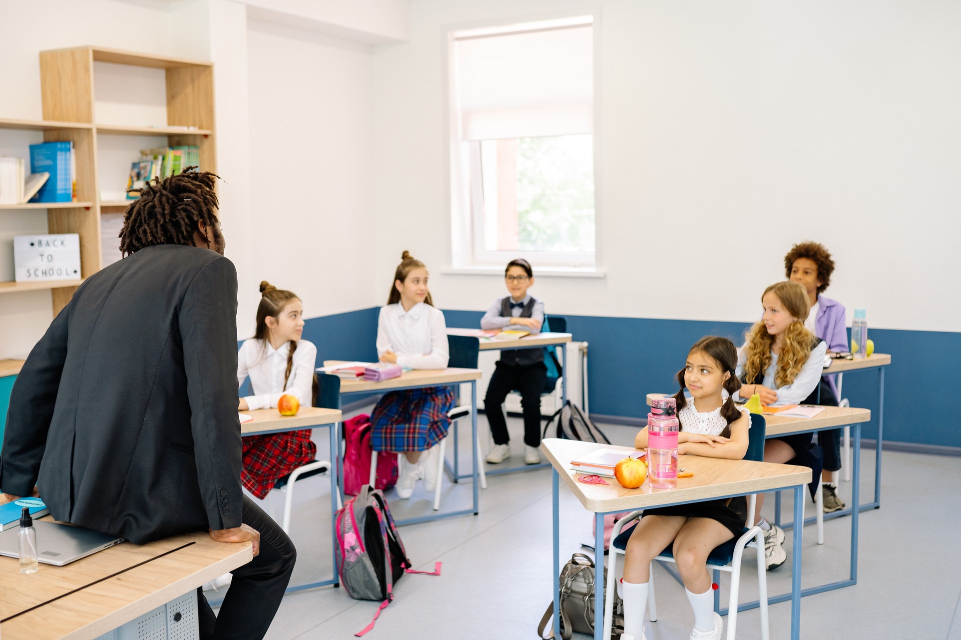 Teacher talks to a small classroom and uses Bloom