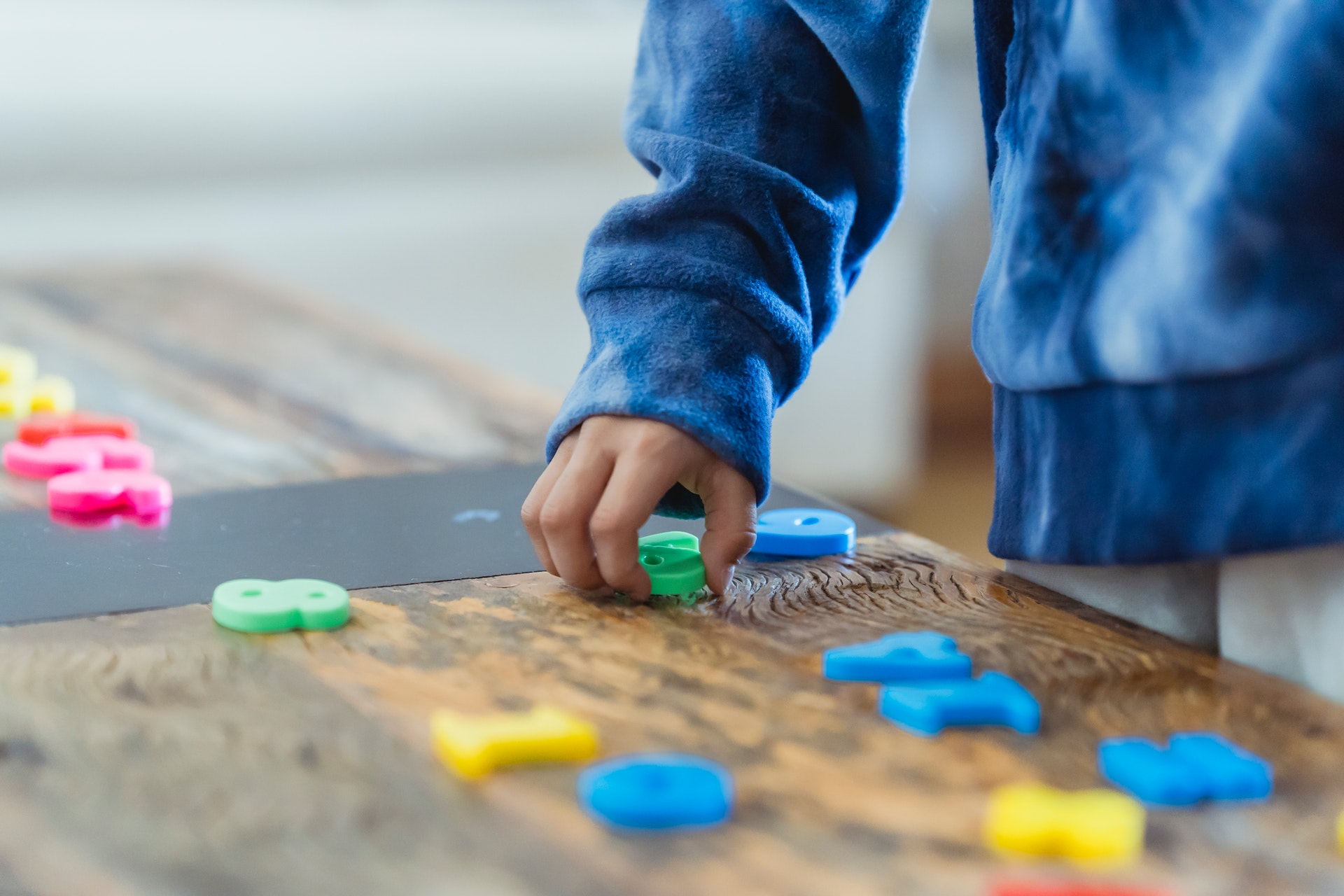 Student plays with math manipulatives and numbers.